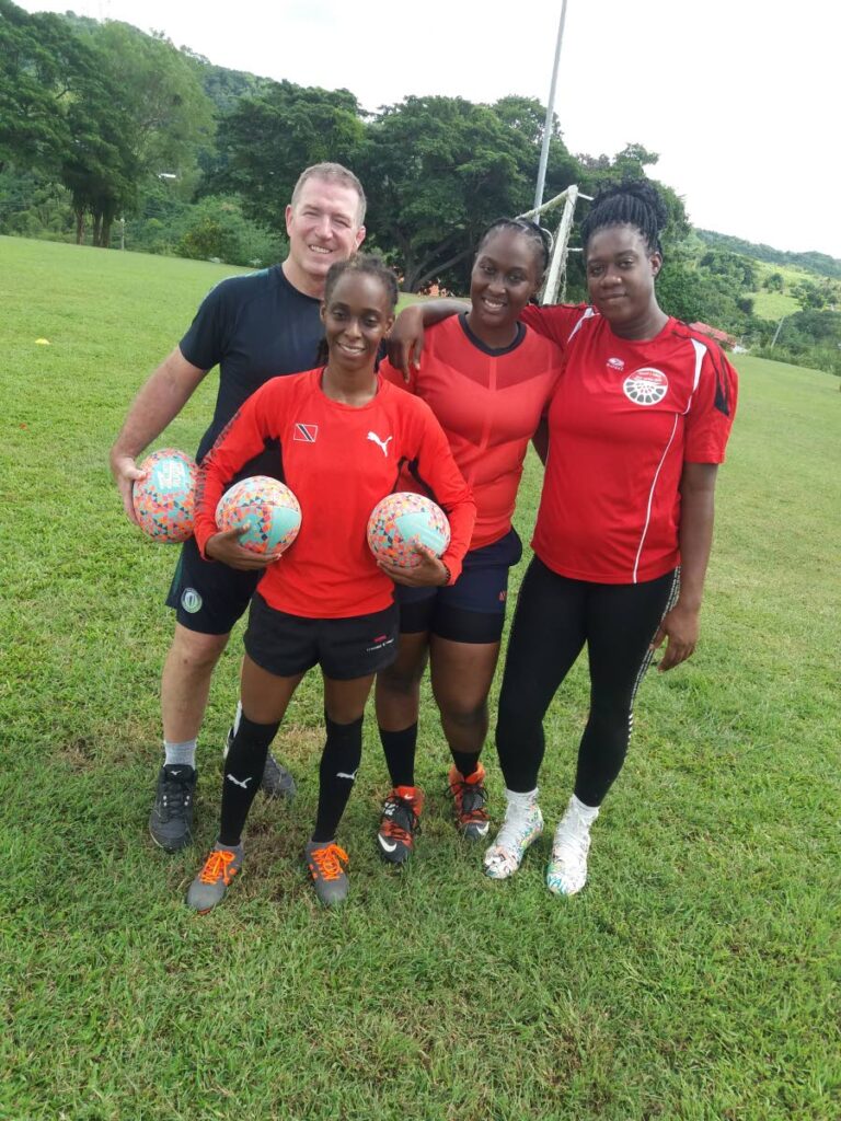 Rugby coach Scott Harland of Canada (left), with Tobago Rugby Club players Shun-Shauna Mason (second from left), Keifa Des Vignes (second from right) and Tenile Duncan. -