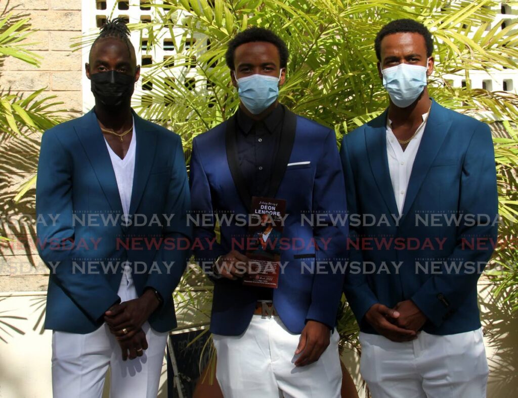 (Left to right) Abilene Wildcats’ Jereem Richards,left, Nathan and Jonathan Farinha, at the funeral for teammate Deon Lendore, at the Santa Rosa RC Chruch, Arima, on Thursday. - AYANNA KINSALE