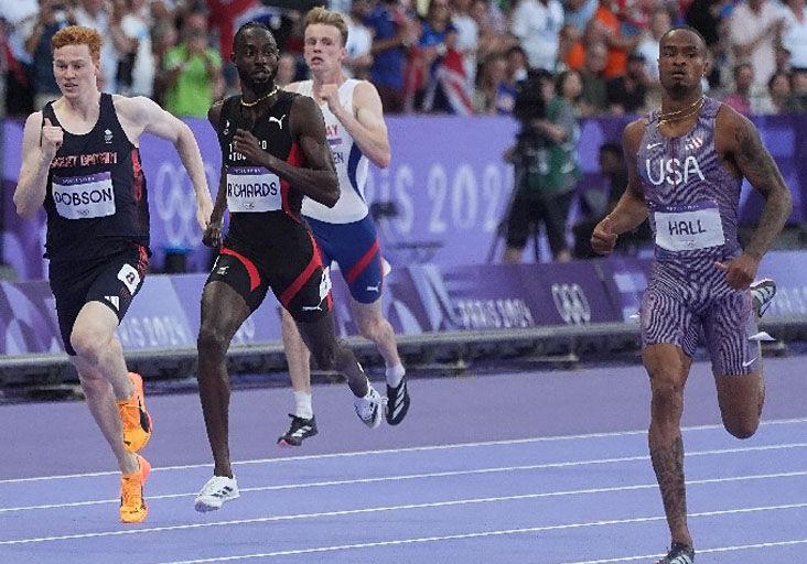 PODIUM PURSUIT: Jereem “The Dream” Richards, second from left, en route to a second-place finish in the opening Olympic Games men’s 400 metres semi-final heat at the Stade France, in Paris, yesterday. Richards clocked 44.33 seconds to finish behind American Quincy Hall, right, the winner in 43.95. Briton Charlie Dobson, left, and Norway’s Havard Ingvaldsen, second from right, were fourth and seventh, respectively, clocking 44.48 and 45.60. Richards and Hall will run in today’s final.   —Photo: BRENT STUBBS (Image obtained at trinidadexpress.com)